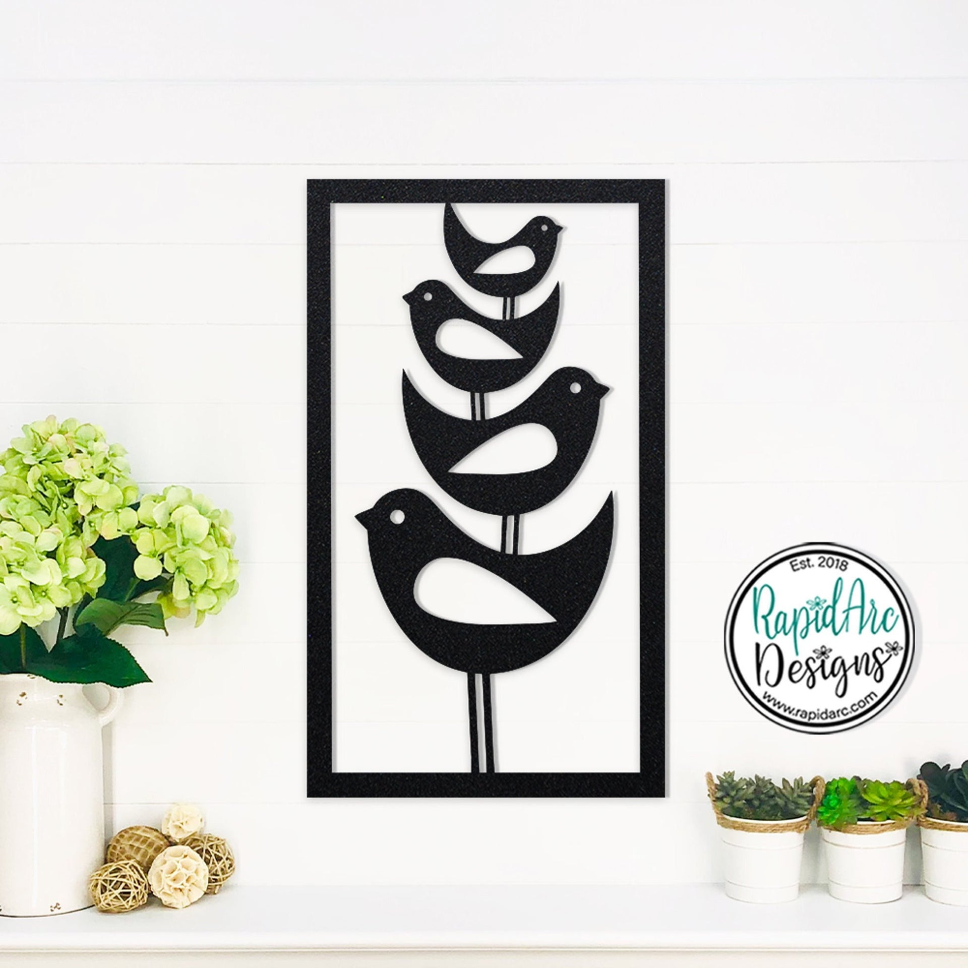 Rectangular metal wall art of four mid century modern style birds stacked one on top of another.